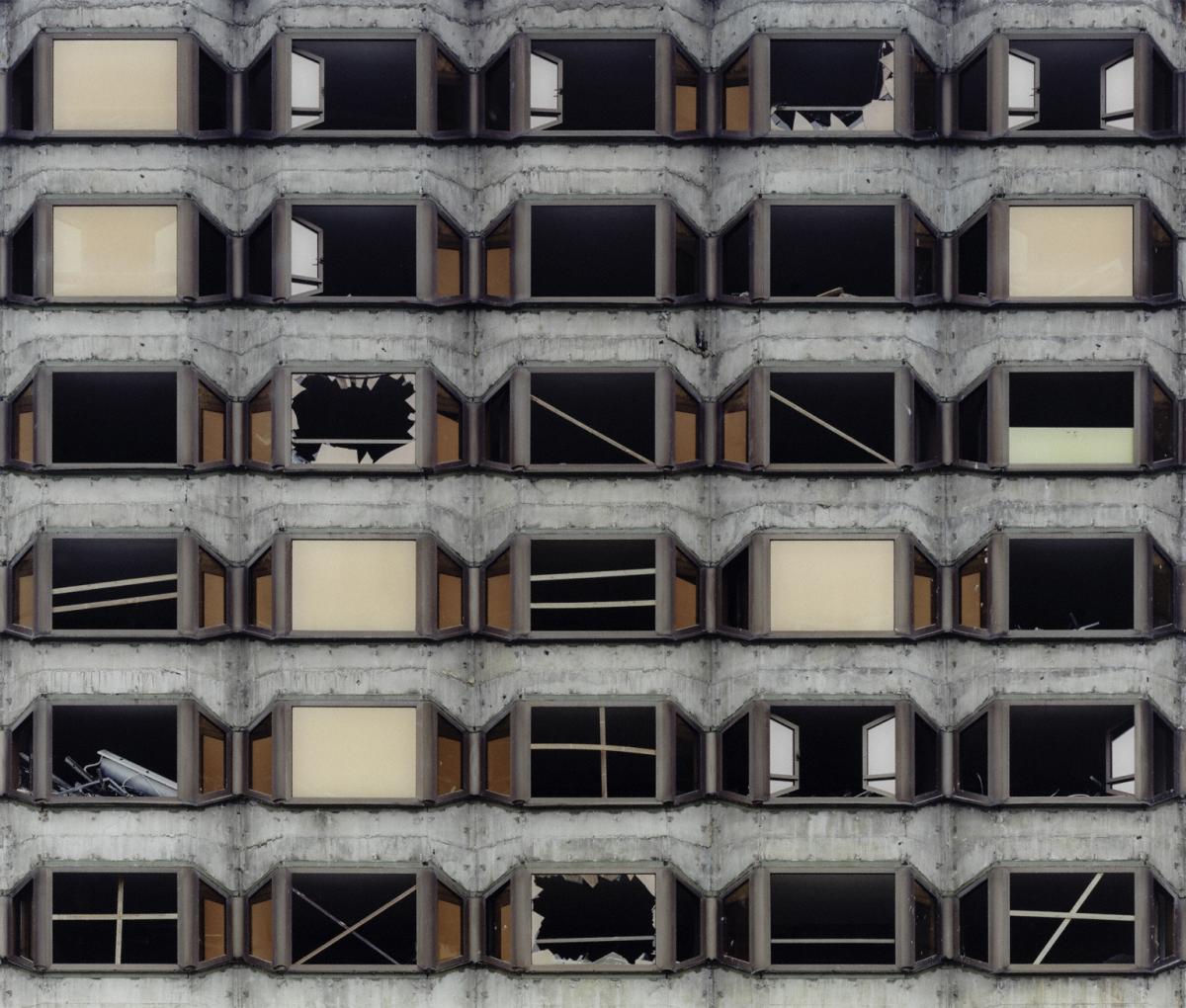 Grid of dilapidated windows of building