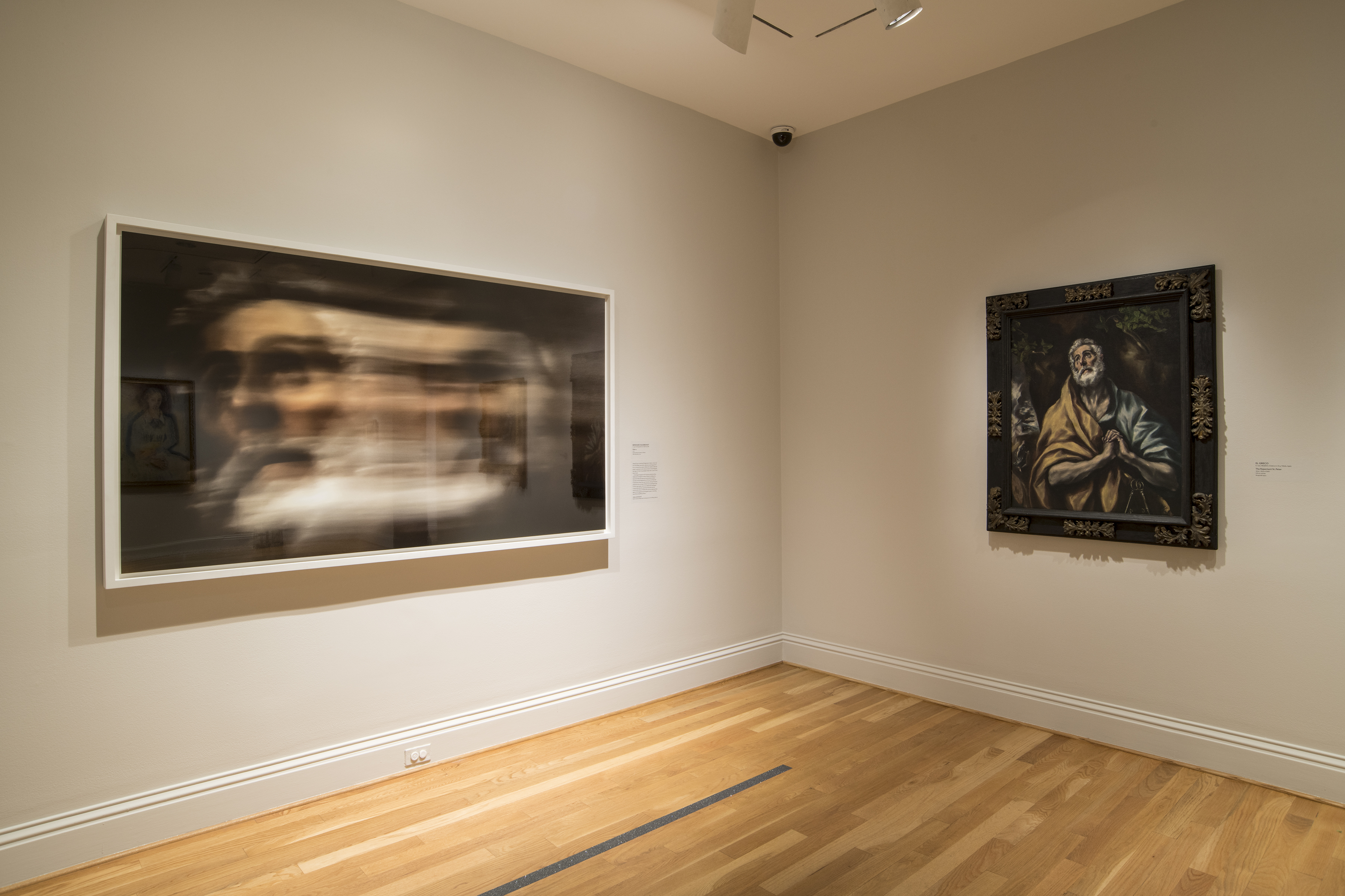 installation view of blurred photograph of man on left with similar painting of man on right