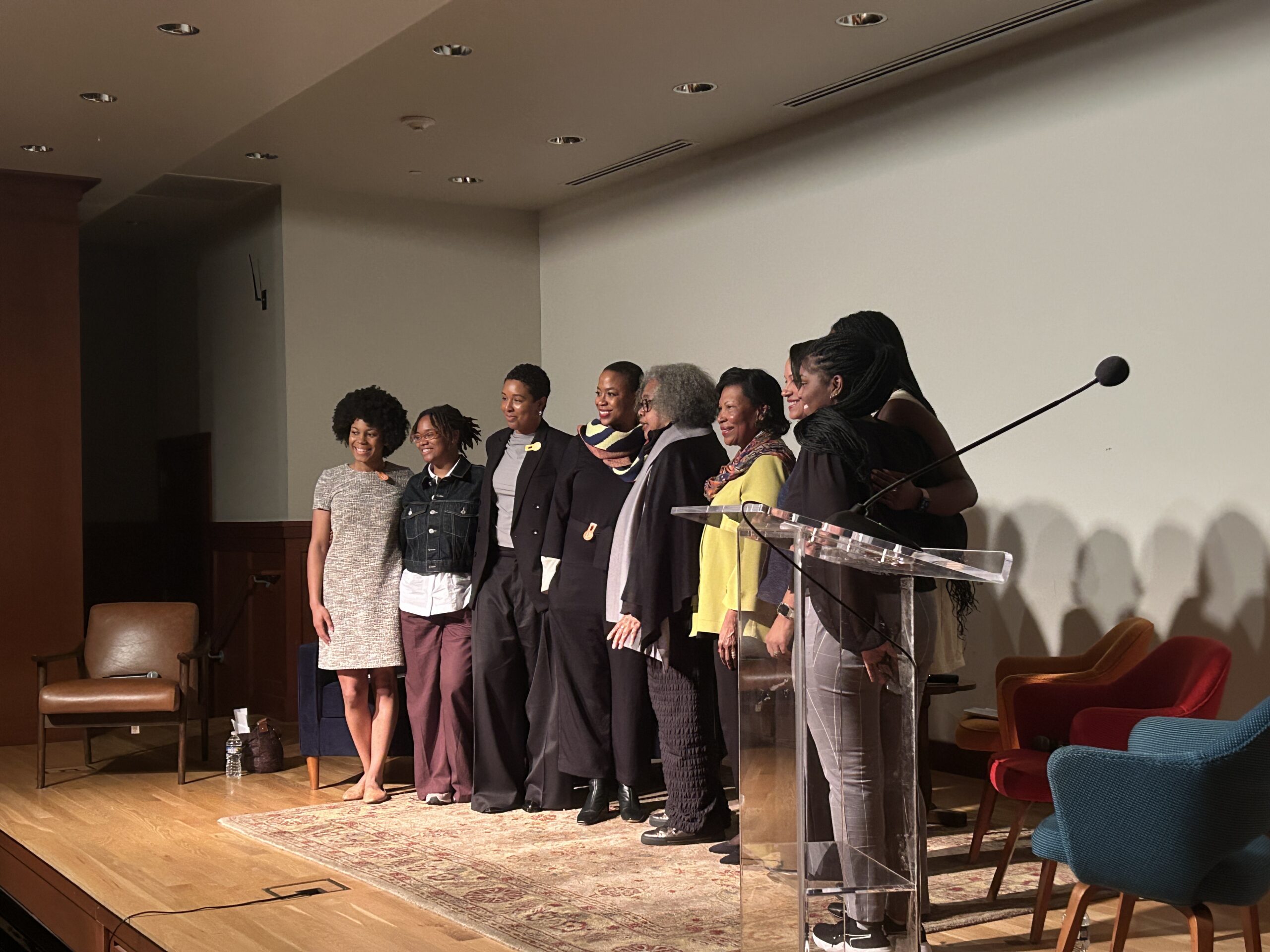 Porter Colloquium panelists standing and smiling together for camera