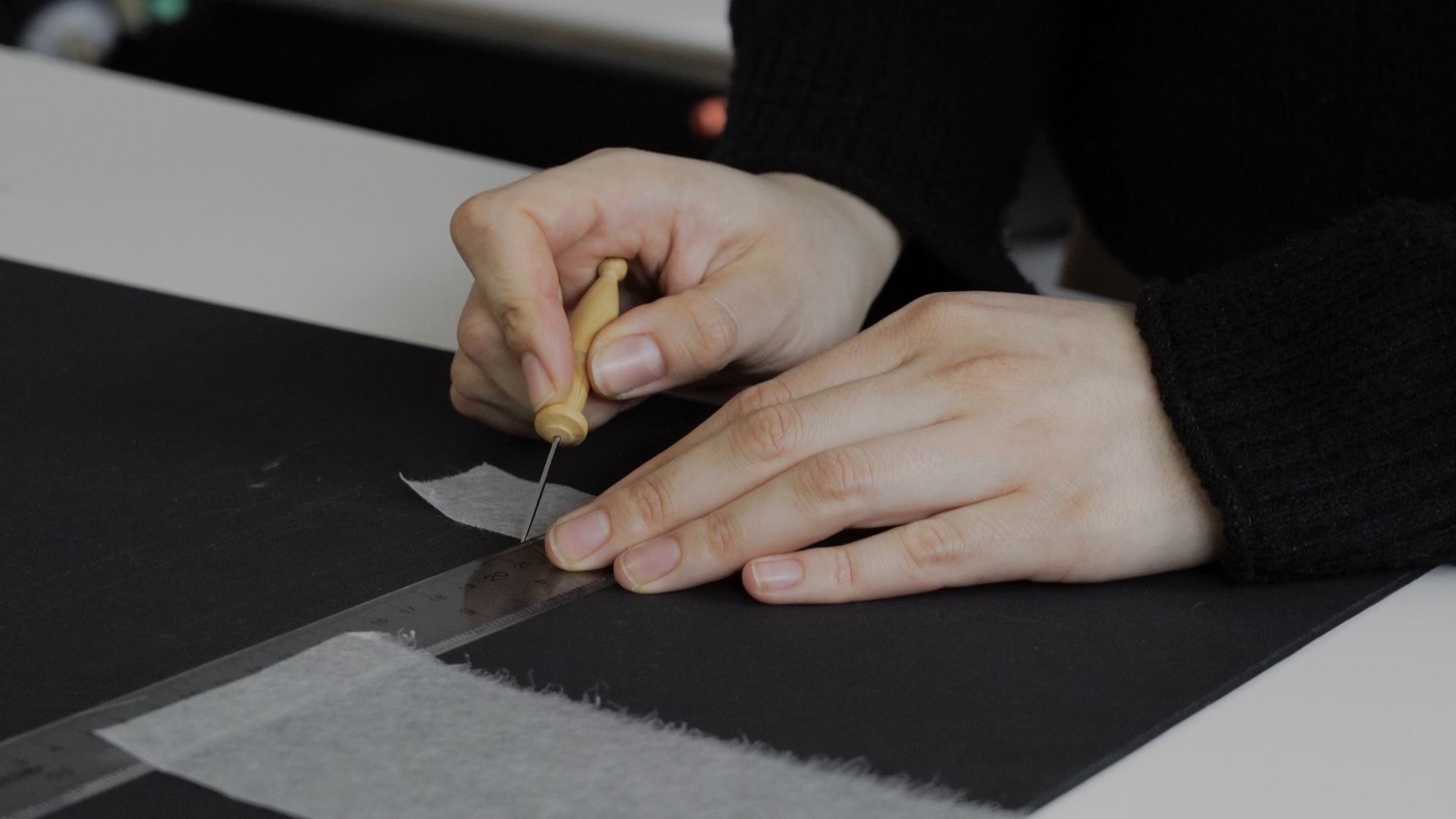 Hannah working on matting artwork on paper