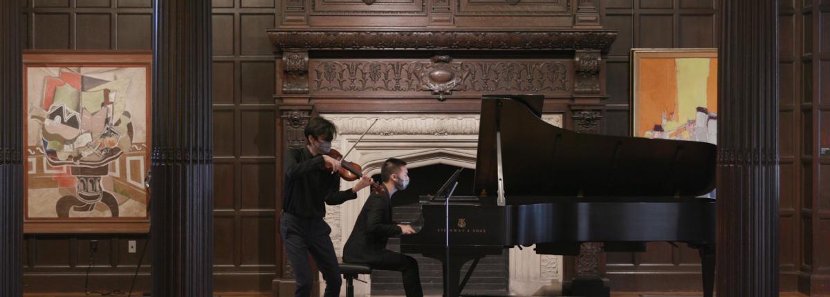 Photo of violinist and pianist performing in the Music Room