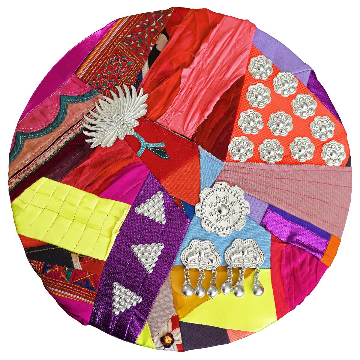 Collage circle made with colorful fabrics and embellishments