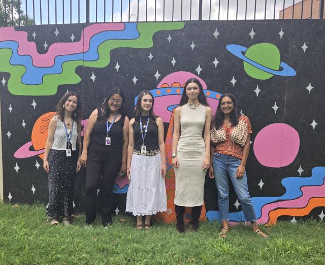 Group photo of summer 2024 interns by THEARC mural