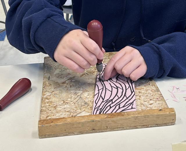 Photograph of student making a print