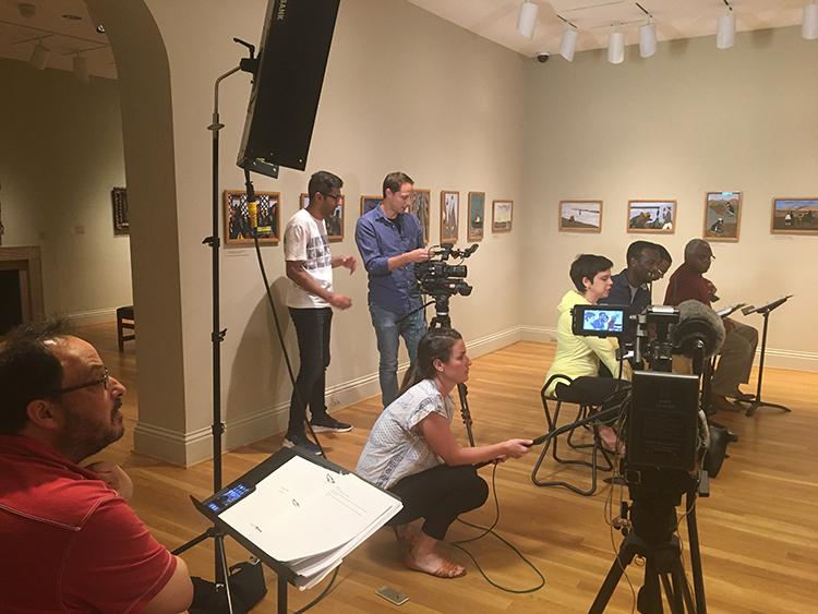 Videographers Rob Migrin and Shaun Mir set up the scene for the recording of Annalisa Dias’s “A Legacy of Chains” while director Derek Goldman looks on.