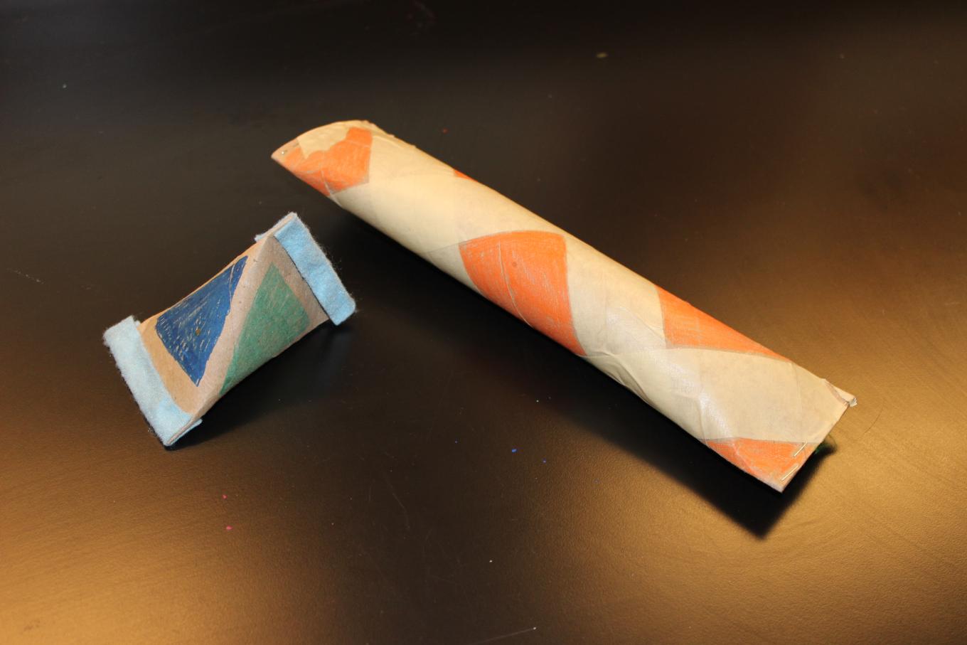 (Option 2 examples) A triangular maraca made out of a toilet paper roll (on left) and a rain stick made out of a paper towel roll (on right). Photo: Hayley Prihoda