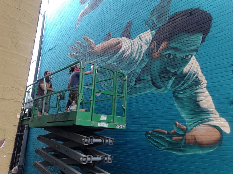 Artist James Bullough on day 4 creating a mural at 905 U Street, NW