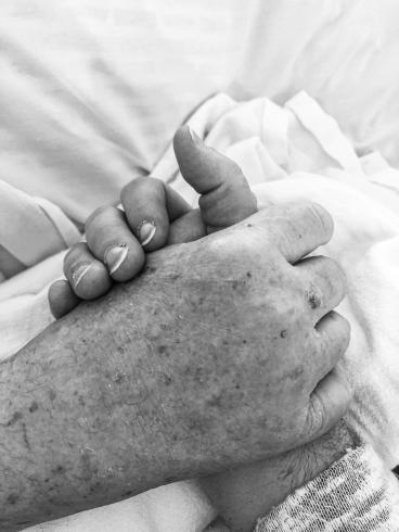 Black and white photograph of holding hands