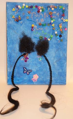 Blue painted canvas with glued beads and two braided strands of hair.