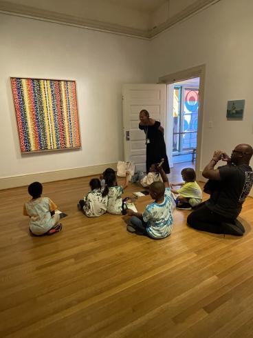 Phillips educator teaching elementary students about artwork in gallery.