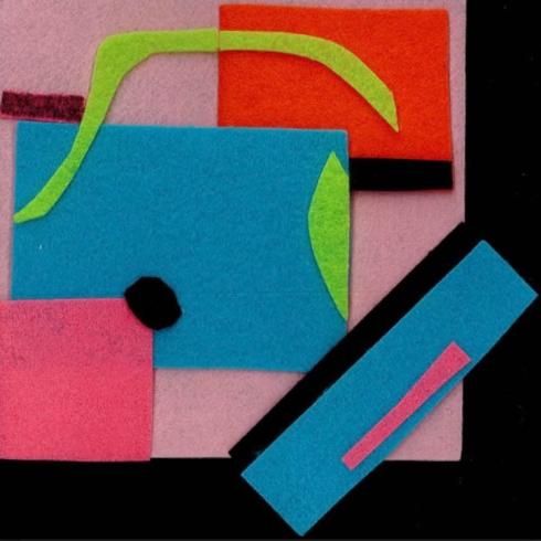 Geometric felt shapes in blue, green, and pink.