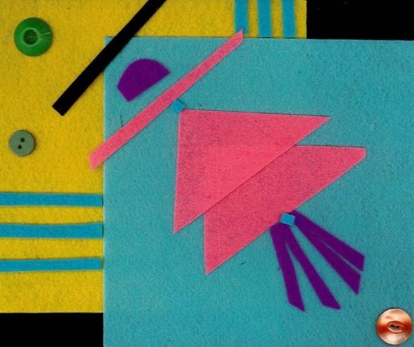 Geometric felt shapes in blue, pink, and yellow.