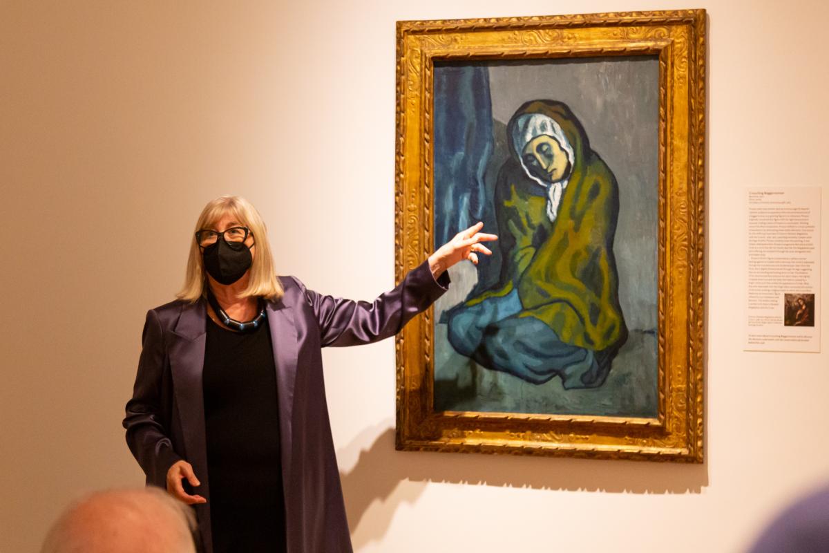 Sue Frank pointing at a Picasso painting on a tour