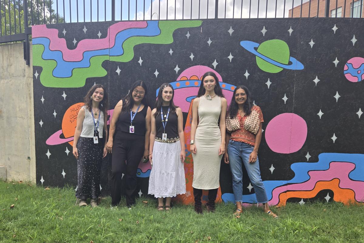 Group photo of summer 2024 interns by THEARC mural