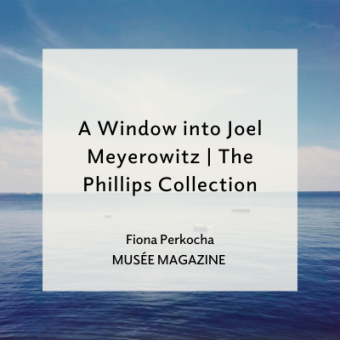 Photography of a blue sky and white clouds. A blue sea with three small boats. Text overlay reads "A Window into Joel Meyerowitz | The Phillips Collection, Fiona Perkocha, Musee Magazine'